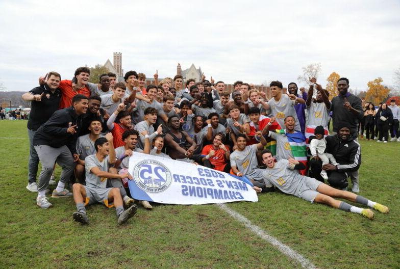 The Elmira College Men's Soccer Team poses with the Empire 8 Championship banner after their win